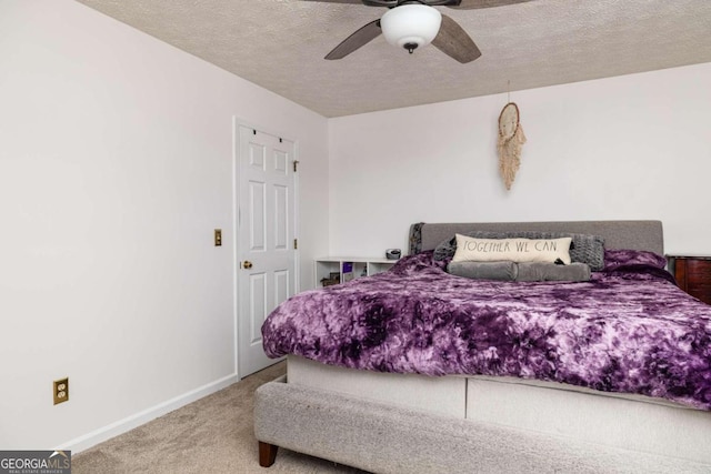 bedroom featuring ceiling fan, a textured ceiling, and carpet flooring