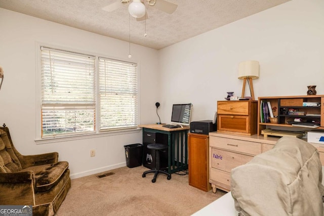 office with ceiling fan, light colored carpet, and a textured ceiling