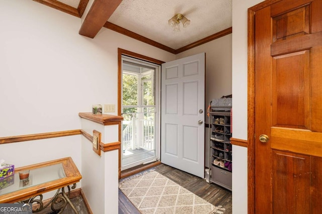 foyer with ornamental molding, a textured ceiling, beamed ceiling, and dark hardwood / wood-style floors