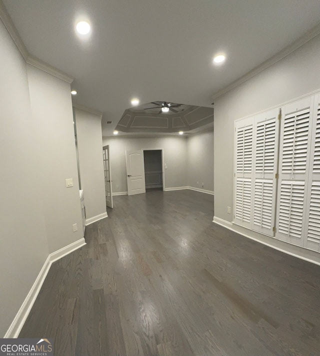 interior space featuring dark wood-type flooring, crown molding, and ceiling fan