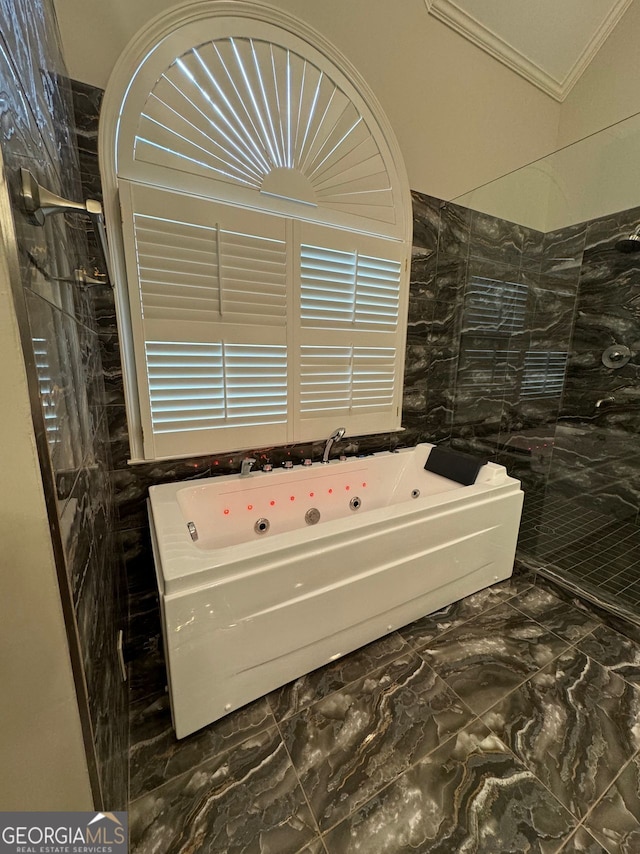 bathroom featuring ornamental molding and shower with separate bathtub