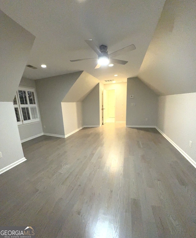 bonus room featuring ceiling fan, vaulted ceiling, a textured ceiling, and hardwood / wood-style floors