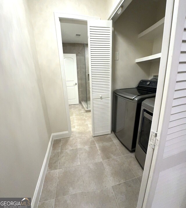 laundry room with separate washer and dryer and light tile patterned floors