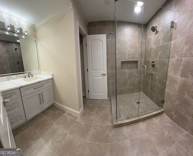 bathroom with ornamental molding, tile patterned flooring, a shower with door, and vanity