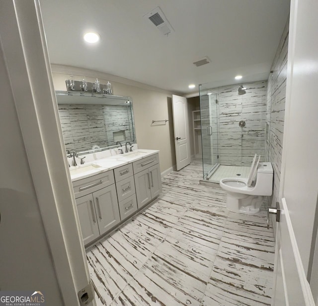 bathroom featuring an enclosed shower, vanity, and toilet