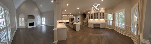 kitchen featuring an inviting chandelier, high vaulted ceiling, and dark hardwood / wood-style flooring