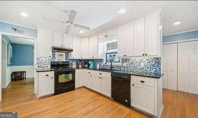 kitchen with sink, light hardwood / wood-style floors, white cabinetry, and black appliances