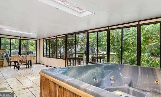 unfurnished sunroom with a skylight and a jacuzzi