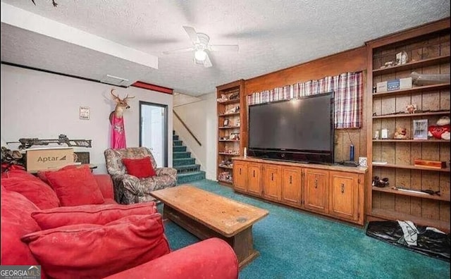 living room with ceiling fan, a textured ceiling, and carpet