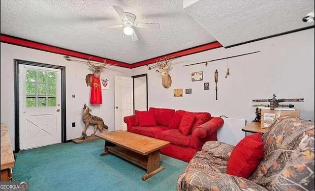 living room with a textured ceiling, ceiling fan, and carpet floors