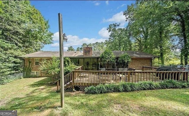 back of house featuring a yard and a deck