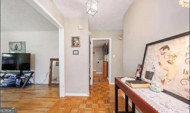 corridor featuring a textured ceiling and light parquet flooring