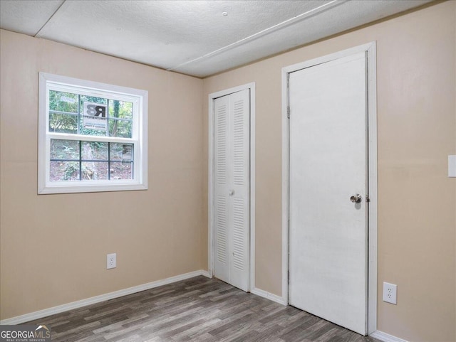 unfurnished bedroom featuring wood-type flooring