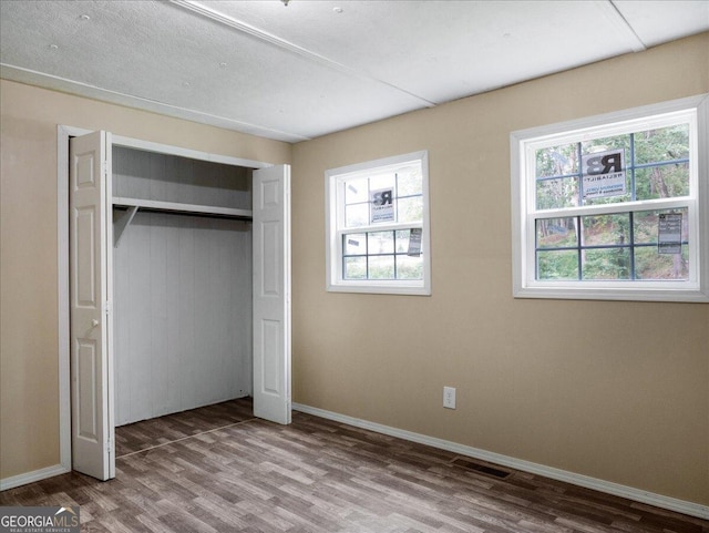 unfurnished bedroom featuring light hardwood / wood-style flooring and a closet