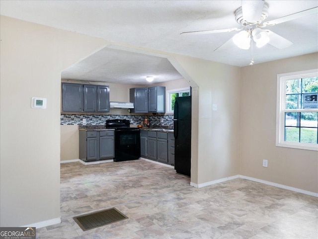 kitchen with gray cabinets, tasteful backsplash, black appliances, exhaust hood, and ceiling fan