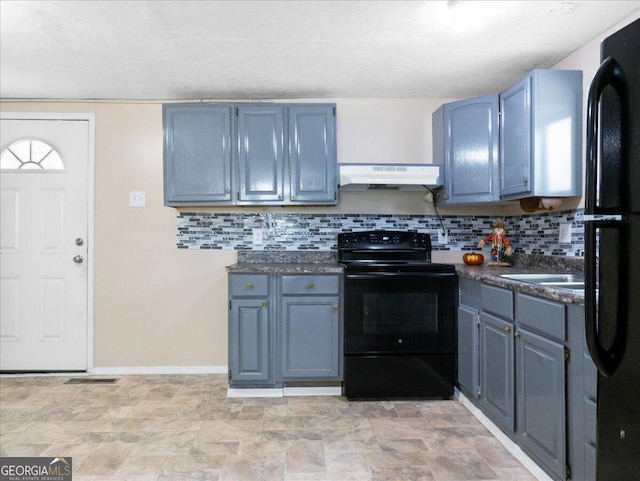 kitchen featuring black appliances, blue cabinets, and decorative backsplash