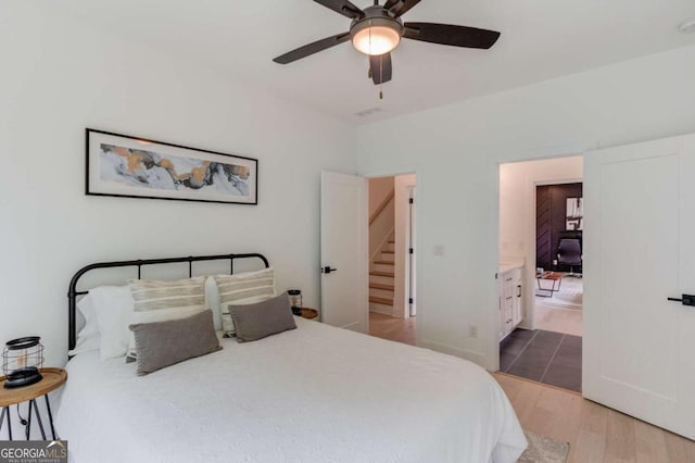 bedroom featuring ceiling fan, connected bathroom, and hardwood / wood-style floors