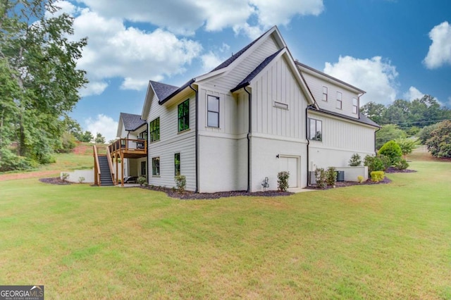 back of property featuring a lawn and a deck