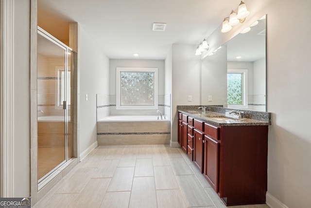 bathroom with independent shower and bath and vanity