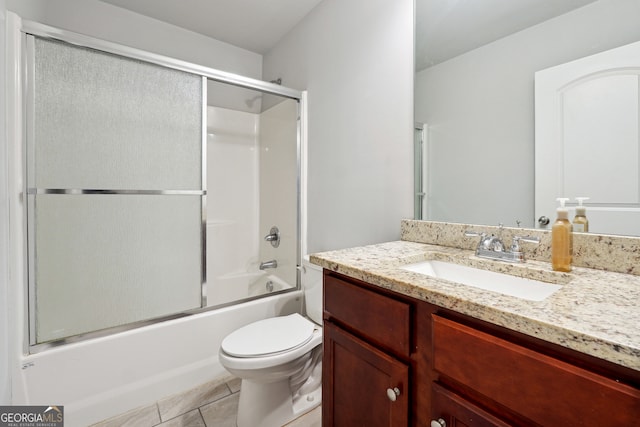 full bathroom with combined bath / shower with glass door, vanity, toilet, and tile patterned floors