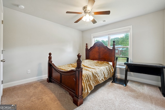 bedroom with ceiling fan and light colored carpet