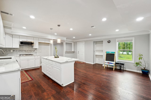 kitchen featuring a kitchen island, dark wood-type flooring, extractor fan, and white cabinets