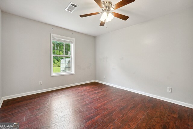 spare room with ceiling fan and dark wood-type flooring