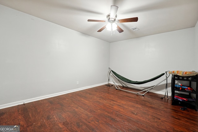 bedroom with ceiling fan and dark wood-type flooring