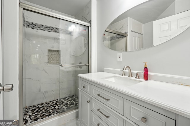 bathroom featuring vanity and a shower with door