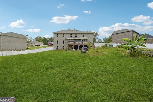 rear view of property featuring a lawn