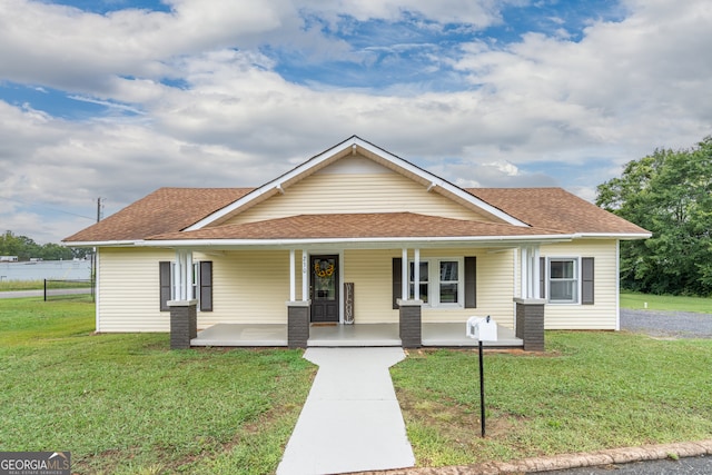 view of front of house featuring a front yard and covered porch