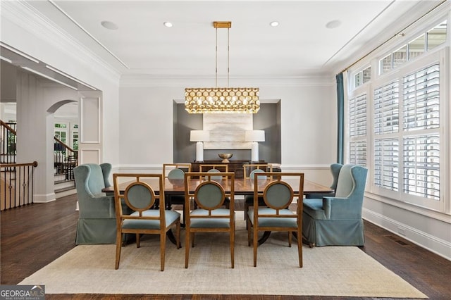 dining space with dark hardwood / wood-style floors and a healthy amount of sunlight