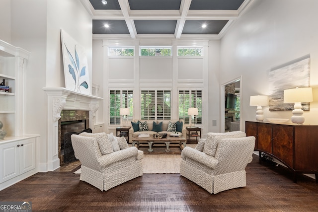 living room with a wealth of natural light, coffered ceiling, and a towering ceiling