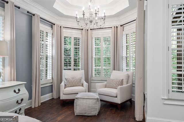 sitting room with a chandelier, a raised ceiling, crown molding, and dark hardwood / wood-style flooring