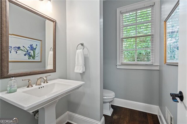 bathroom featuring hardwood / wood-style flooring and toilet