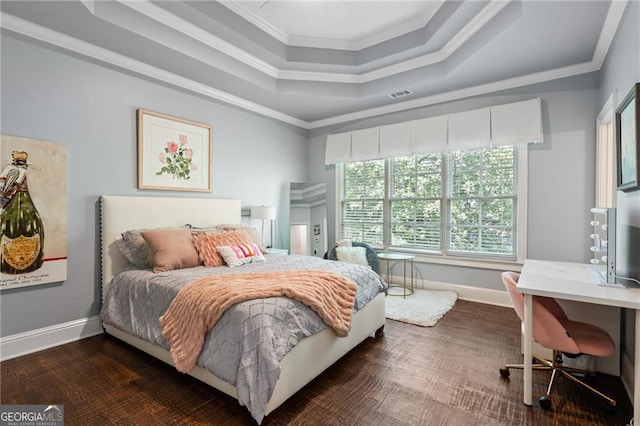 bedroom featuring crown molding, dark hardwood / wood-style floors, and a raised ceiling