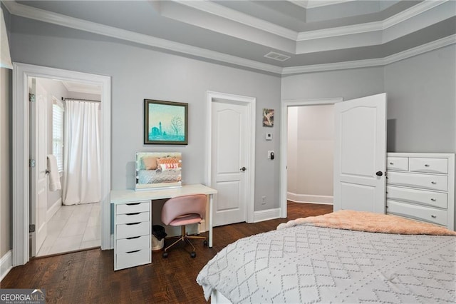 bedroom featuring crown molding, dark wood-type flooring, and a raised ceiling