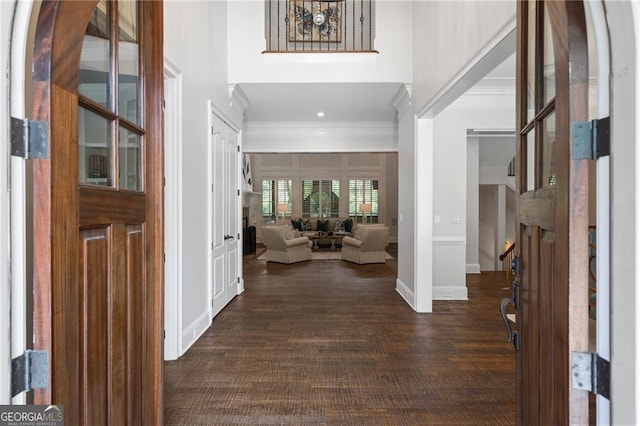 foyer entrance featuring crown molding and dark hardwood / wood-style flooring