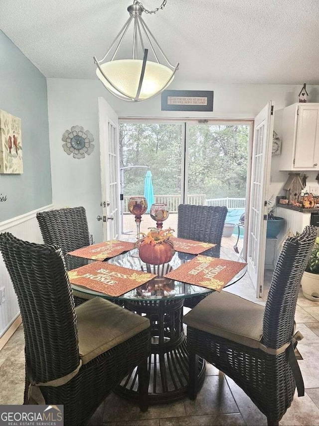 dining room featuring a textured ceiling