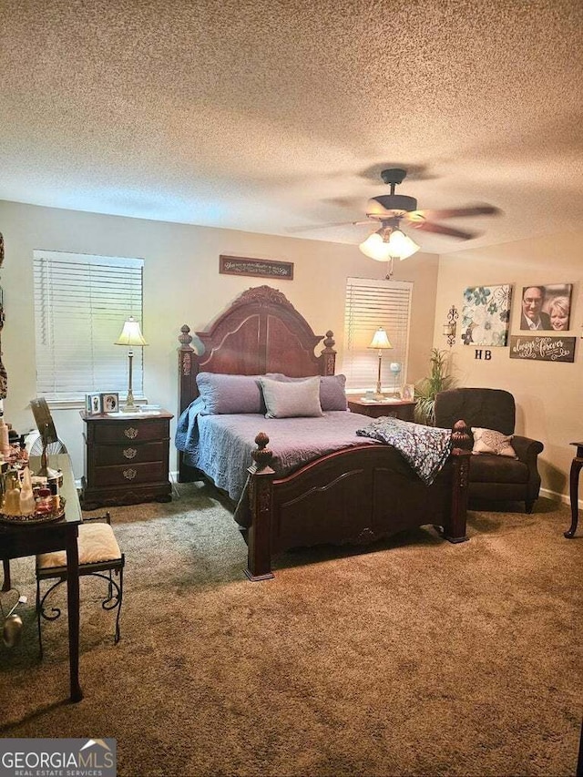 bedroom with ceiling fan, carpet floors, and a textured ceiling