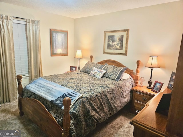 bedroom with a textured ceiling and carpet floors