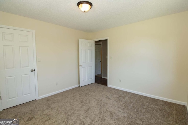 spare room with carpet floors and a textured ceiling