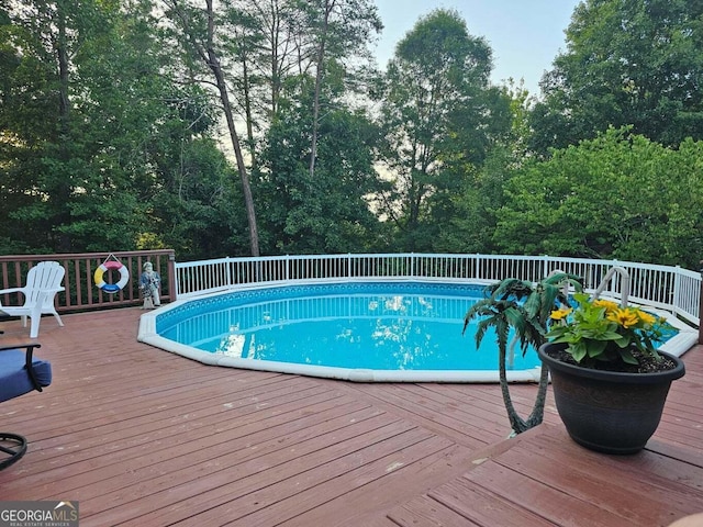 view of swimming pool with a deck