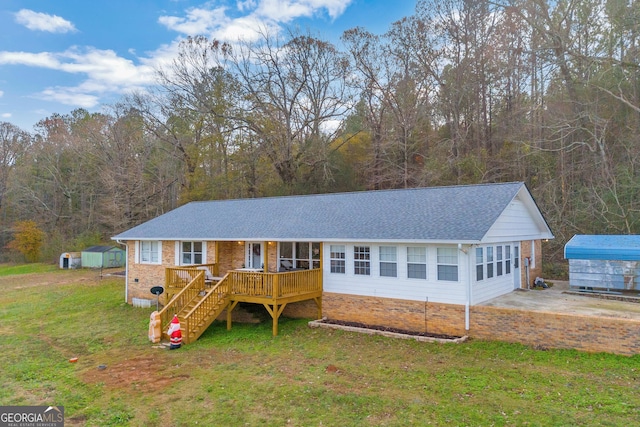 ranch-style home featuring an outbuilding and a front yard