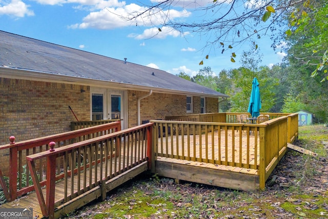 wooden terrace with a storage shed