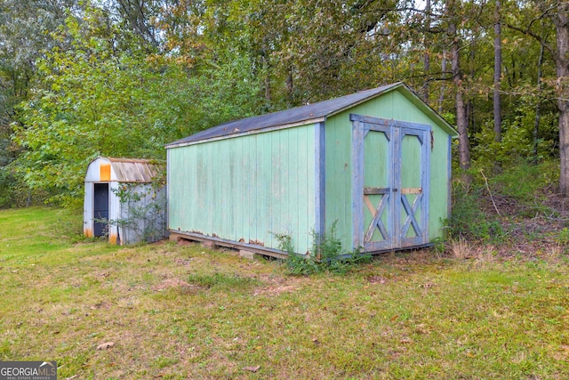 view of outbuilding with a yard