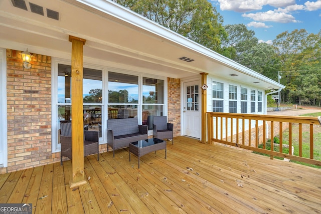 deck featuring outdoor lounge area