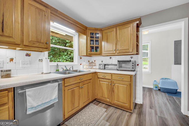 kitchen featuring dishwasher, light wood-type flooring, sink, and a wealth of natural light