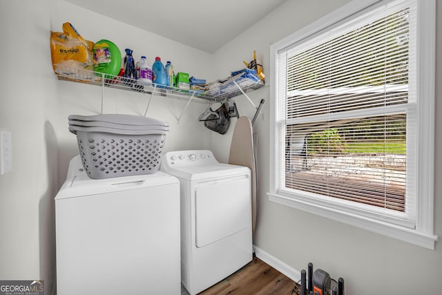 clothes washing area featuring dark hardwood / wood-style floors and washing machine and clothes dryer