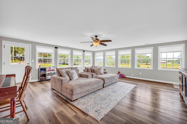 living room featuring a fireplace, hardwood / wood-style floors, plenty of natural light, and ceiling fan